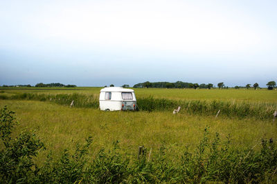 Barn on field against clear sky