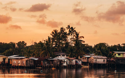 Reflection of palm trees in water at sunset