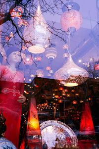 Illuminated lanterns hanging on tree in winter