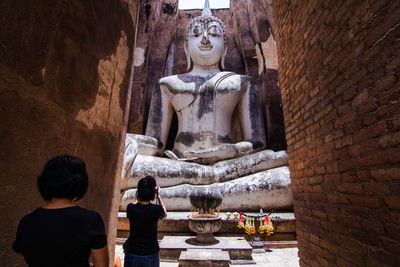 Statue of buddha against building