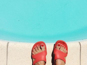 Low section of woman standing on pool 