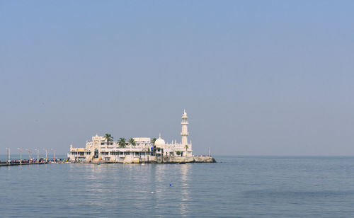 View of sea and buildings against sky