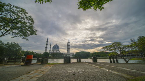 View of temple building against cloudy sky