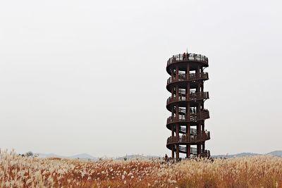 View of tower on field against clear sky