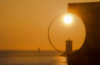 Scenic view of sea against orange sky