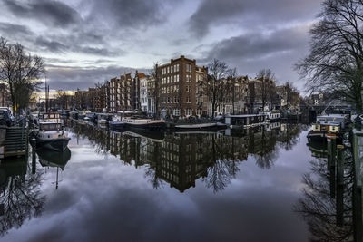 Reflection of canal houses and houseboats in the brouwersgracht canal on an early winter morning