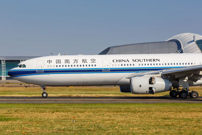 Airplane on airport runway against clear sky