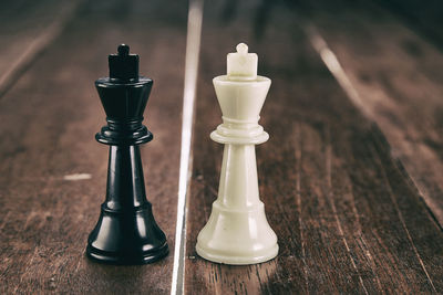 Close-up of chess pieces on wooden table