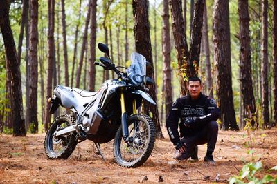 Man riding bicycle on dirt road in forest