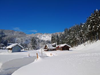 Scenic view of snowcapped mountains against clear blue sky