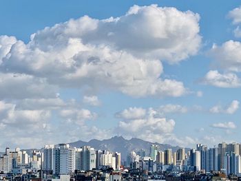 Modern buildings in city against sky