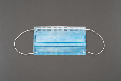 Directly above shot of blue telephone against white background