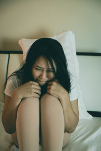 Midsection of woman sitting at home