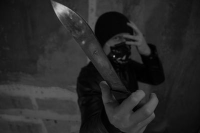 Portrait of murder holding knife