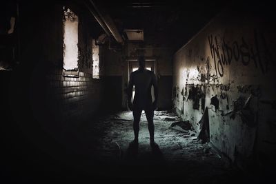 Silhouette of man walking in corridor