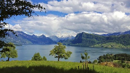 Scenic view of lake and mountains against sky