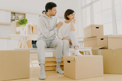 Couple sitting on table in room