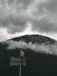 Low angle view of road sign against sky