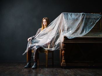 Portrait of woman sitting on chair