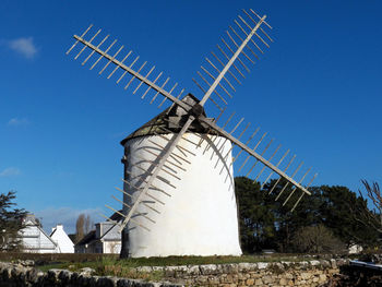 Low angle view of traditional windmill against sky