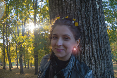 Portrait of smiling young woman in forest