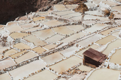 Little rusty warehouse in the middle of the pools at maras salt mine.