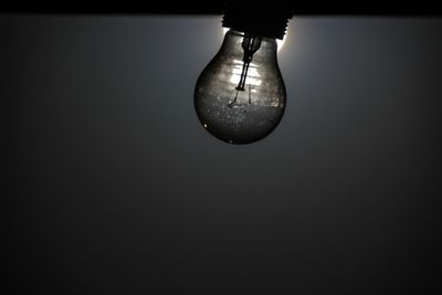 Close-up of lamp over black background