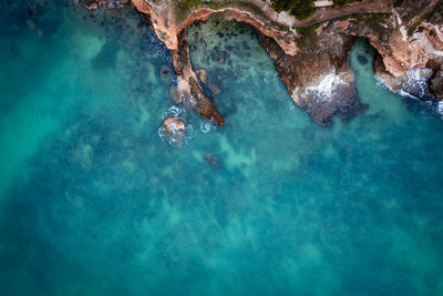 High angle view of rocks in sea