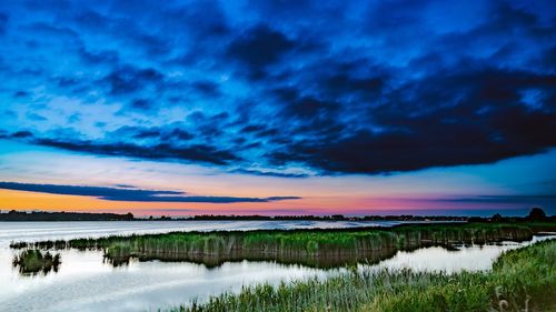 Scenic view of lake against sky during sunset