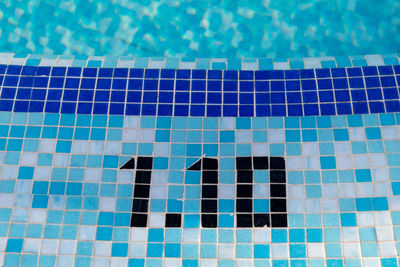 Depth sign on edge of swimming pool