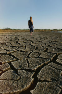 Full length of woman standing on land against sky