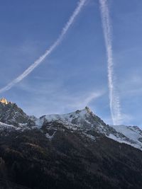 Low angle view of mountain range against blue sky