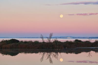 Scenic view of lake against romantic sky at sunset