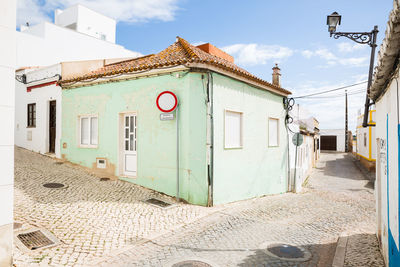 Street amidst buildings against sky