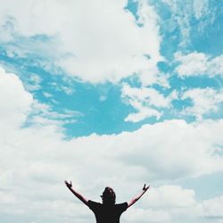 Low angle view of people against cloudy sky