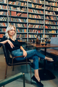 Portrait of woman sitting on book