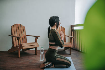 Woman sitting on chair at home