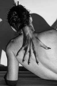 Double exposure image of hand and shirtless woman