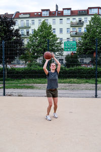 Full length of woman playing basketball