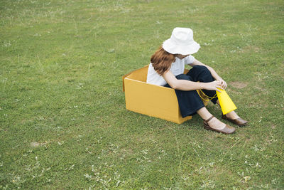 High angle view of couple sitting on field