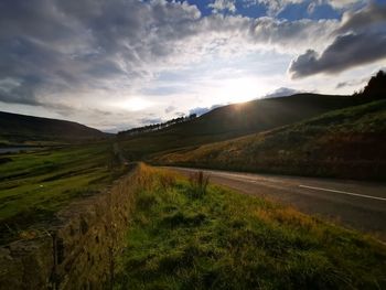 Empty road along countryside landscape