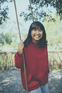 Asian teenager toothy smiling with happiness in park