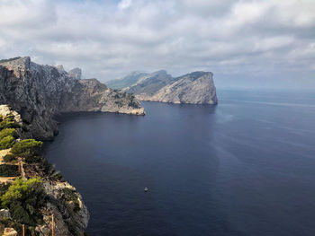 Scenic view of sea against sky with cape, cliff, rock