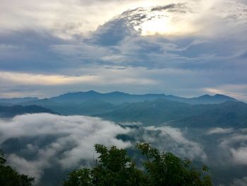 Scenic view of mountains against cloudy sky