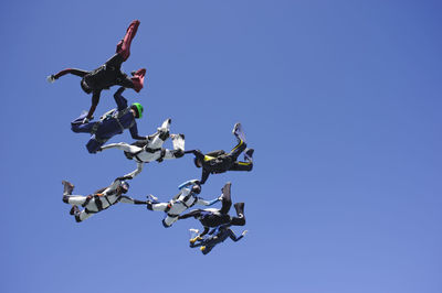 Skydivers holding hands mid-air