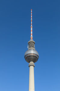 Low angle view of communications tower against sky