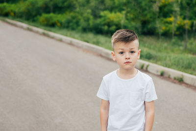 Portrait of boy standing outdoors