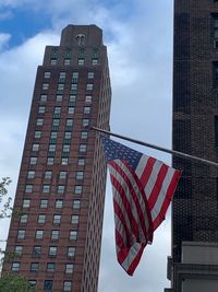 Low angle view of flag against buildings