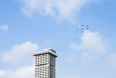 Low angle view of airplane flying against sky