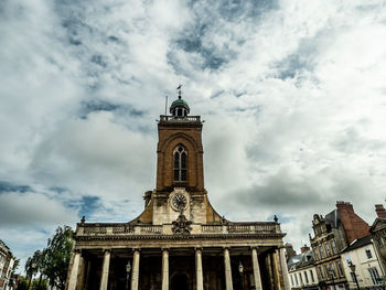 Low angle view of historical building against cloudy sky